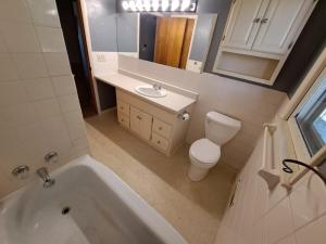 a bathroom with a tub and a toilet and a sink at Location! Large Home, Country Views, Entertainment in Dubuque +17 photos