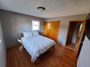 a bedroom with a bed and a window at Location! Large Home, Country Views, Entertainment in Dubuque