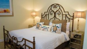 a bedroom with a bed with pillows and two lamps at Penthouse Jr Unrivaled Luxury Insane Views apts in South Padre Island