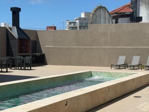 a swimming pool on the roof of a building at Nogales Apartamentos in Mar del Plata