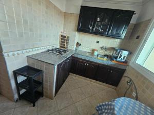 a kitchen with a stove and a counter top at Appartement famille plage in El Jadida