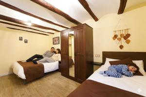 three people laying on beds in a room at Casa Ladislada in Cella +96 photos