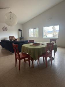 a living room with a table and chairs and a couch at Mezzanine Loft Above the Barn in Whitehorse