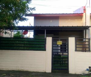 a house with a garage with a sign on the door at 2G's Staycation Home in San Felix