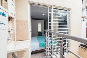 a balcony with a door leading to a bedroom at Miraflores in Cali