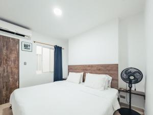 una camera con letto bianco e ventilatore di Miraflores a Cali