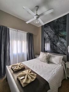 a bedroom with a bed with two towels on it at Hotel Jorgito in Mar del Plata