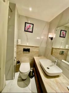 a bathroom with a white toilet and a sink at hotel red creek in Visakhapatnam