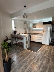 a kitchen with a white refrigerator and a table at Stylish Modern apartment with automatic parking in Buenos Aires +32 photos
