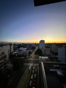 a view of a city street with cars at sunset at Stylish Modern apartment with automatic parking in Buenos Aires
