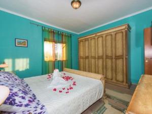 a bedroom with a bed with flowers on it at Holiday Home Marin AS with Pool in Trbounje +17 photos