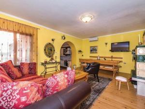 a living room with a couch and a piano at Holiday Home Marin AS with Pool in Trbounje