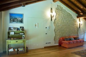 ein Wohnzimmer mit einem Sofa und einer Steinmauer in der Unterkunft agriturismo Cà Roer in San Zenone