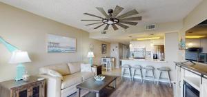 a living room with a couch and a table and a kitchen at Beachfront Space Coast Gem with Heated Pool, Sleeps 4 in Cape Canaveral