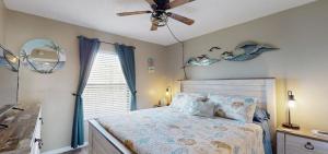 a bedroom with a bed and a ceiling fan at Beachfront Space Coast Gem with Heated Pool, Sleeps 4 in Cape Canaveral