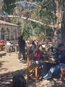 a group of people sitting at tables in a park at La querencia in Vaqueros +3 photos