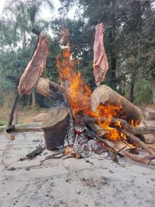 a fire with some meat on top of it at La querencia in Vaqueros