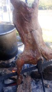 a piece of meat is cooking on a grill at La querencia in Vaqueros