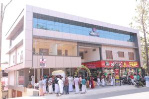 a group of people standing outside of a building at Janani Silver Apartment Chathannoor, Kottiyam in Kottiyam