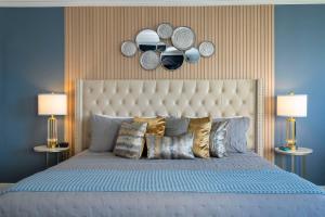 a bedroom with a large bed with plates on the wall at Studio with Private Terrace and Volcano Bay View Near Epic Universe in Orlando