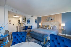 a bedroom with a bed and a table and chairs at Studio with Private Terrace and Volcano Bay View Near Epic Universe in Orlando