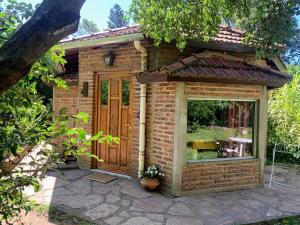 a brick building with a window and a door at Casita de campo in Villa Ciudad Parque