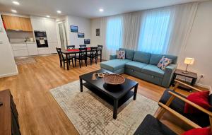 een woonkamer met een blauwe bank en een tafel bij Apartamento Sonho Terra in Ponta Delgada