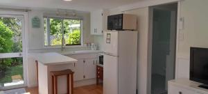 a kitchen with a white refrigerator and a sink at Green on Queen in Richmond
