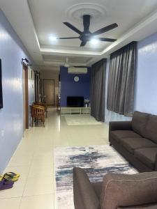 a living room with a couch and a ceiling fan at SK Homestay Bukit Rangin Kuantan in Kuantan
