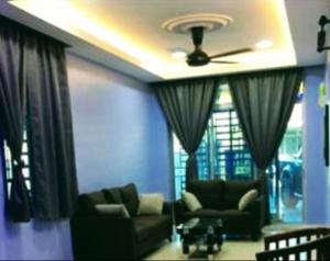 a living room with two couches and a ceiling fan at SK Homestay Bukit Rangin Kuantan in Kuantan