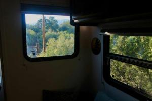 a window on a train looking out into the woods at Comfortable Guest RV With EV charger Semi Rural Area in Bodfish +8 photos