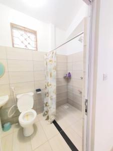 a bathroom with a toilet and a shower at Tee,s Homestay in Mtwapa