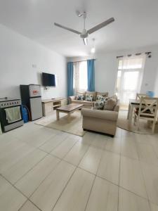 a living room with a couch and a table at Tee,s Homestay in Mtwapa