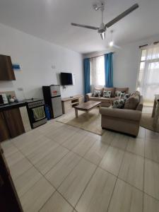 a living room with a couch and a table at Tee,s Homestay in Mtwapa