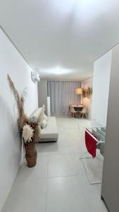 a living room with a couch and a table at Mila rooftop apto 308 in Tamandaré