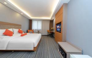 a hotel room with a large bed and a tv at Days Inn Xi'an City Center in Xi'an