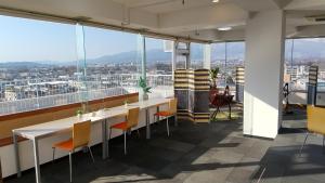 a dining room with a view of a city at 佐久一萬里温泉ホテル in Saku