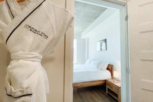 una habitación con una cama y una toalla colgada en la puerta en Corporate Stays Monarc 2 Bedrooms, en Saint-Laurent