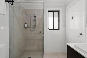 a bathroom with a shower with a glass door at The Stayover - Your Wine Country Base in North Rothbury +16 photos