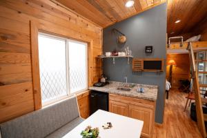 a kitchen with wooden walls and a window at WeeCasa Tiny Home Resort in Lyons