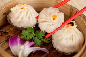 a bowl filled with cupcakes with chopsticks and flowers at Placement For Cloud Hunting in Suy Tung Su