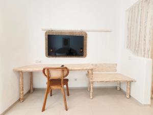 a table with a chair and a mirror on a wall at Villa Aurora - Stylish 2 Bedroom Villa with Mediterranean Style in Badung
