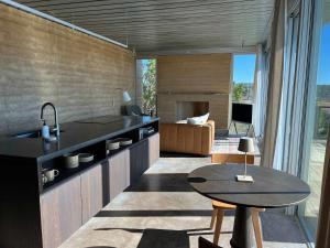a kitchen with a sink and a table in a room at Red-tail Cabin at Gamenthaler in Fredericksburg