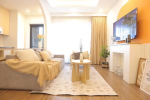 a living room with a couch and a fireplace at FLC Sea Tower QUY NHƠN-Căn Hộ Du Lịch 5 Sao-Cách Biển 40m-Hồ Bơi-View Biển in Quy Nhon