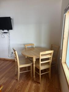 a wooden table and chairs in a room with a tv at Cliffside Hideaway-Renovations & upgrades coming! in Hammond +8 photos