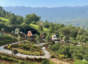 a group of houses on a hill with a garden at Tà Đùng M'Nông Eco Glamping 