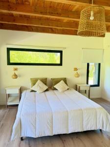 a bedroom with a large bed with a wooden ceiling at Exclusive luxury house in a great location - 12 guest in Lago Puelo +37 photos