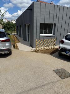 two cars parked in front of a building at Le Petit Larmet in Besançon
