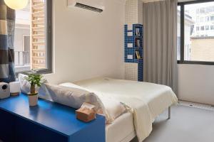 Postel nebo postele na pokoji v ubytování Tiaohai Living Youth Hotel + 86 fotografií