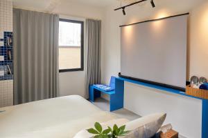 En eller flere senge i et værelse på Tiaohai Living Youth Hotel